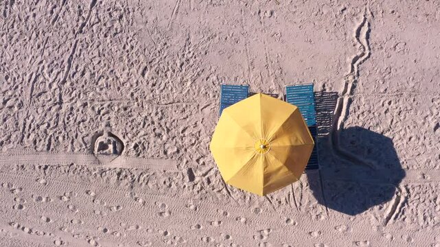 Umbrella and beach chair alone on sand 4k
