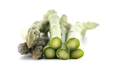 Close-up of fresh green asparagus on a white background, ready to be cooked.
