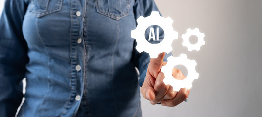 A woman's hand in a blue shirt pointing at gears with 