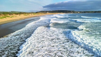 Captivating views of the ocean waves crashing powerfully on the shore, showcasing a beautifully...