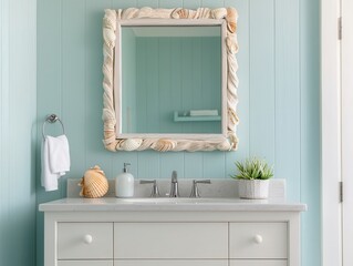 A coastal-themed bathroom vanity with a seashell-framed mirror, light blue walls, white cabinet, and minimal decor featuring a plant and soap dispenser.
