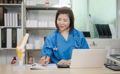 A middle-aged Asian female doctor at her desk,explaining various bone and joint diseases like...