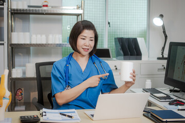 A middle-aged Asian female doctor at her desk,explaining various bone and joint diseases like...