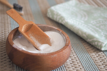 Bowl of baking soda and towel on a carpet 