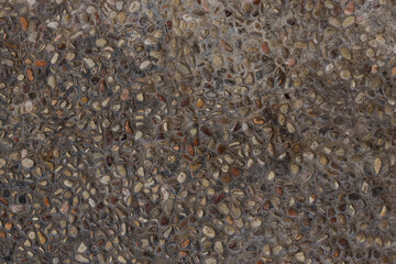 Top View Of Textured Surface Composed Of Small, Irregular Pebbles Or Gravel Embedded In Concrete