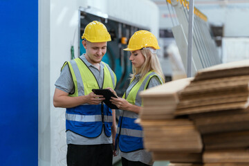 paper cardboard manufacture factory concept, industry worker person working with machine to...
