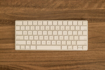 Top View Of Modern White Computer Keyboard On Dark Wooden Desk