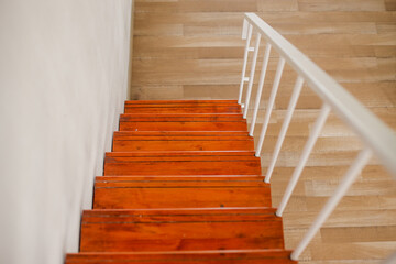 Looking Down Wooden Staircase With White Wall And Metal Railing