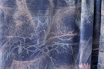 Close Up Of Blue And Beige Patterned Fabric With Flowing Folds And Intricate Designs