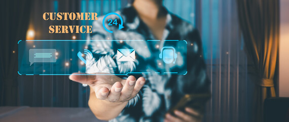 Customer service concept. One person in a tropical shirt holding a phone and showing a glowing digital interface with 24/7 customer support icons for chat, phone, email and help from AI.