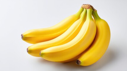 Fresh bananas arranged on a light background, showcasing their vibrant yellow color.