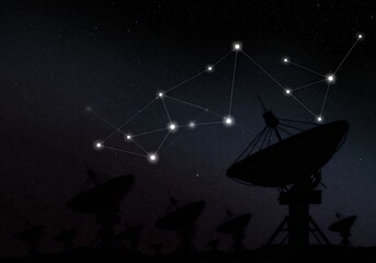 Satellite dishes communicate with the cosmos in a network, reaching out to distant stars under the expanse of the night sky.
