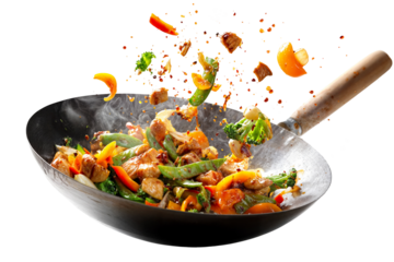 Colorful chicken stir fry with vegetables in hot wok isolated on transparent background with flying ingredients and spices