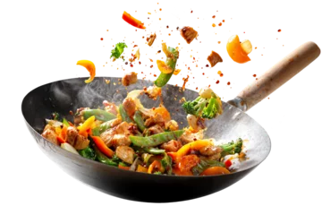 Fototapeten Colorful chicken stir fry with vegetables in hot wok isolated on transparent background with flying ingredients and spices © boxstock production