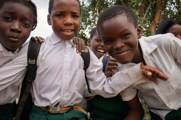 Premium close-up of happy African schoolchildren in uniforms, laughing together outdoors. A powerful and uplifting image capturing real joy, childhood, and cultural connection.
