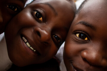 Premium close-up of happy African schoolchildren in uniforms, laughing together outdoors. A powerful and uplifting image capturing real joy, childhood, and cultural connection.