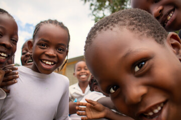 Premium close-up of happy African schoolchildren in uniforms, laughing together outdoors. A powerful and uplifting image capturing real joy, childhood, and cultural connection.