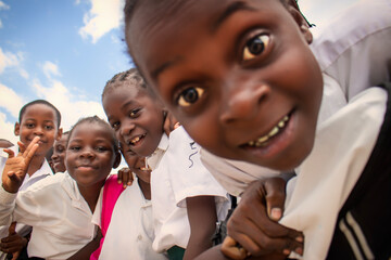 Premium close-up of happy African schoolchildren in uniforms, laughing together outdoors. A powerful and uplifting image capturing real joy, childhood, and cultural connection.