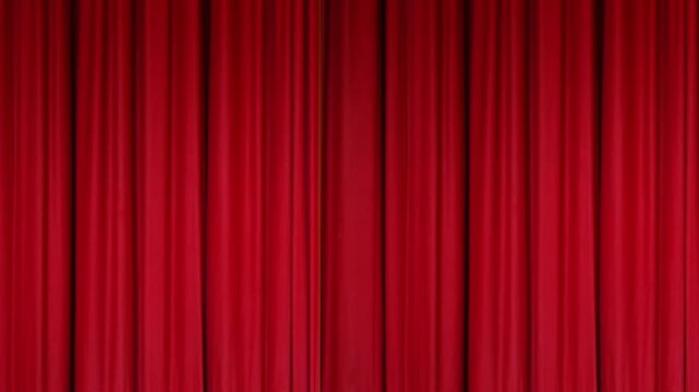 Elegant red curtain opening to reveal a green screen background. Luxurious fabric movement creating cinematic effect. Perfect for transitions, video intros, theater, or stage performance mockups.
