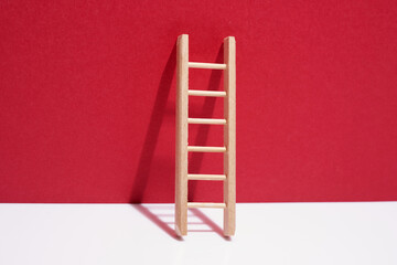 small ladder against red background