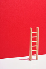 small ladder against red background