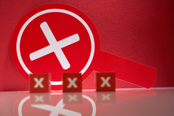 Red round placard with cross sign means rejection. placard with handle to hold