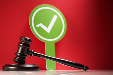 green circle with check mark and gavel hammer.
