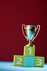 small trophy on the 123 winner podium