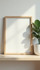 Simple picture frame on shelf beside potted plant, decor, leaves