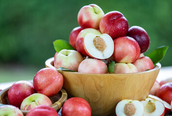 Sweet fruit, fresh Red Nectarine on a natural green background.