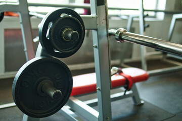 Close-up view of dumbbells, black circular weights, in a gym. 10-kilogram weight. View of weights in a gym.