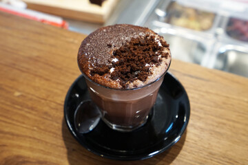 Close up glass of chocolate cocoa drink on wooden table bar