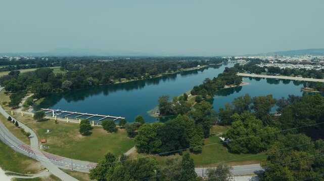 aerial - Jarun Lake with long rowing course, small islands, and surrounding city roads