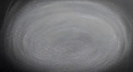 Abstract view of a swirling pattern with grainy texture and varying shades of gray and white tones present