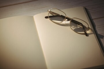 Old fashioned eyeglasses kept on blank book