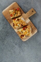Pizza slices on wooden tray