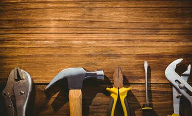Hammer with wooden handle is resting on rustic plank bench in flat design workshop illustration