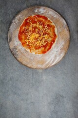 Fresh pizza on wooden cutting board