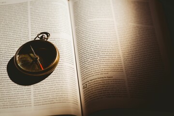 Pocket watch on open book