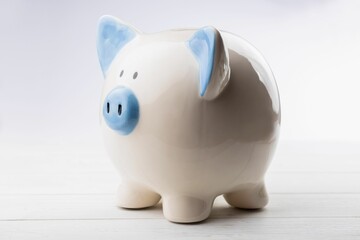 Close-up of piggy bank on wooden table