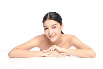 Obraz premium A beautiful young Asian woman with clean, fresh skin against a white background. Skincare, facial treatment, cosmetology, beauty, and spa. An elegant portrait of an Asian woman.