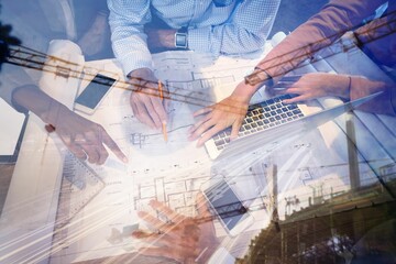 Business people discussing over blueprint in office