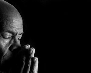 Praying to God with black background stock image stock photo