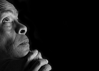 Praying to God with black background stock image stock photo
