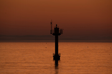 Sunset Over Calm Sea with Silhouette of Ocean Tower