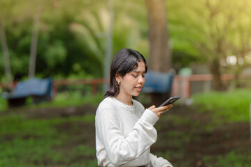 Cute girl recording an audio with her phone. Woman recording a voice message