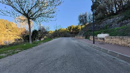 A serene, peaceful winding road meanders through lush, vibrant greenery, perfect for nature walks or scenic drives