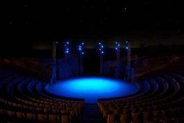 Nighttime Amphitheater Stage: Blue Lit Empty Seats, Starry Sky, Dramatic Mood