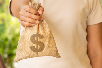woman's hand holding a wallet and giving a bag of money, money saving and investment concept