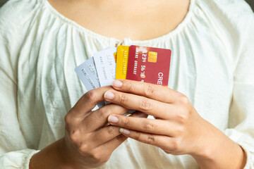 Woman holding several credit cards and he is choosing a credit card to pay and spend Payment for...